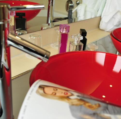 a red bowl of food sitting on top of a counter at Hotel Santo in Karlsruhe