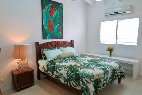 a bedroom with a bed and a lamp and a window at Ocean Point Villa in Saraotou