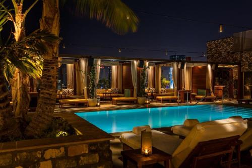 a swimming pool in a hotel at night at Dream Hollywood, by Hyatt in Los Angeles