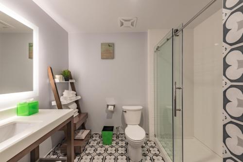 a bathroom with a toilet and a glass shower at Lexen Hotel - North Hollywood Near Universal Studios in North Hollywood