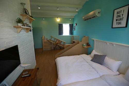 a bedroom with a white bed and a fireplace at Travel Light in Jiaoxi