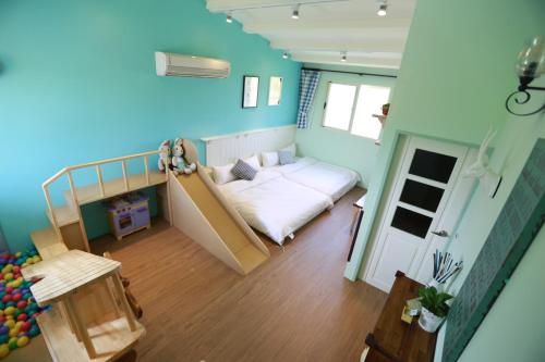 a small room with a bed and a staircase at Travel Light in Jiaoxi