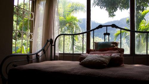 a bed in a room with a large window at Lejartre's Retreat in Mount James