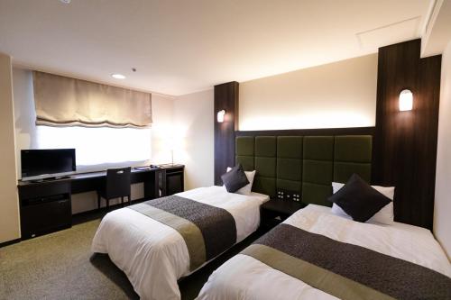 Tempat tidur dalam kamar di Hotel Binario Saga Arashiyama