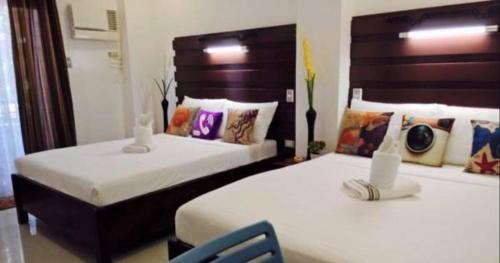 Ένα ή περισσότερα κρεβάτια σε δωμάτιο στο SunValley Tourist Inn