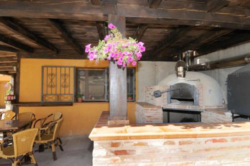 a kitchen with an oven with a table and chairs at Las Ollerias in Deza
