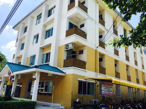 a large white and yellow building at MP House in Ban Rong Khoei