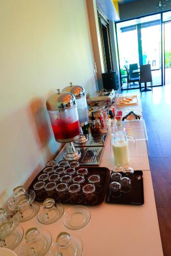 a table with a counter with cupcakes and a mixer at The Glory Gold in Khao Lak