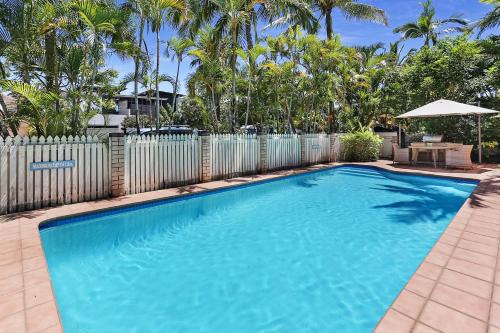 a swimming pool in front of a fence at Low Tide on Noosa Sound - Pet Friendly in Noosa Heads