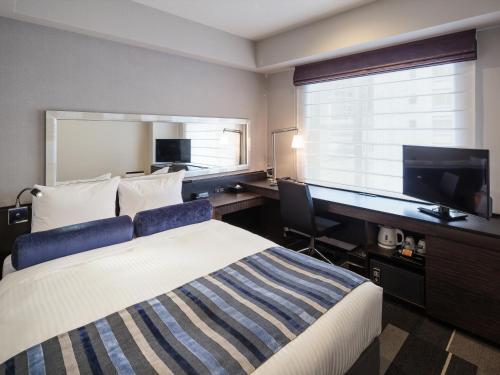 Ένα ή περισσότερα κρεβάτια σε δωμάτιο στο Hotel MYSTAYS PREMIER Dojima
