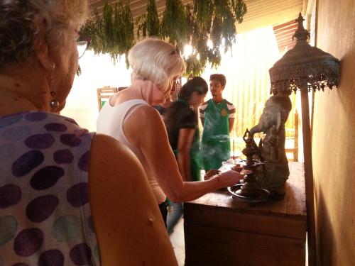 a woman standing at a counter with two children at Saubagya Inn in Anuradhapura