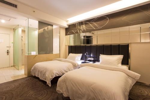a bedroom with three beds and a walk in shower at Metropolo, Hefei, Wanda Plaza, Swan Lake in Hefei