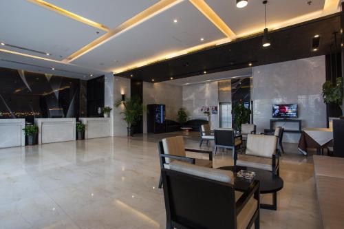 a lobby of a hotel with tables and chairs at Metropolo, Hefei, Wanda Plaza, Swan Lake in Hefei