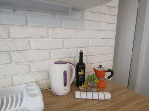 a counter with a toaster and a bottle of wine at Holiday Home Isabella in Vis