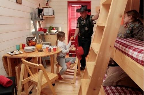 a man and a child in a tiny house at Etangs du Moulin in Suzy