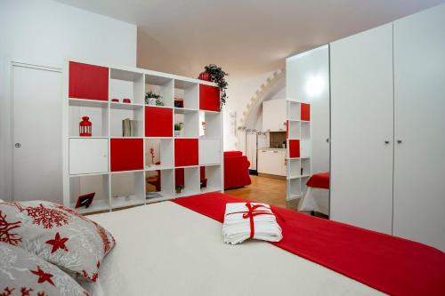 a bedroom with a bed with red and white furniture at Sicily Mon Amour Ortigia in Siracusa