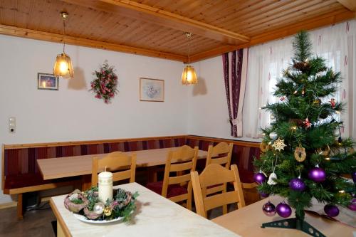 a christmas tree in a dining room with a table at Haus Ladner - Josef und Marianne in Kappl