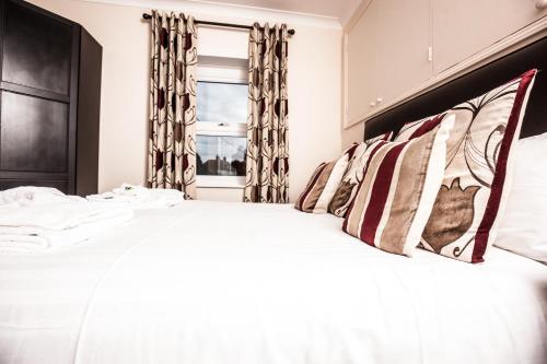 a bed with white sheets and pillows in a bedroom at Bridge Hotel Brandon in Brandon