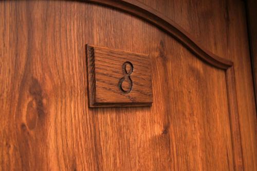 a wooden door with the number six on it at Penzion Pod Dratnikem in Svratka
