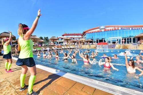 a group of people in the swimming pool at Aquapark Health Resort & Medical SPA Panorama Morska All Inclusive in Jarosławiec