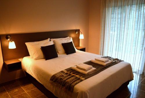 a bedroom with a large bed with towels on it at Marathon Eco Stay in Marathon