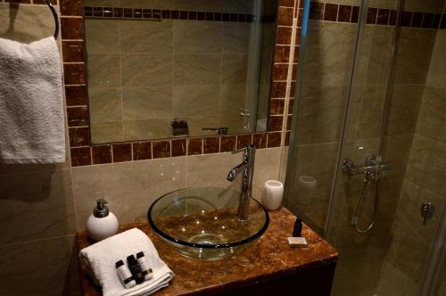 a bathroom with a glass sink with a shower at Marathon Eco Stay in Marathon
