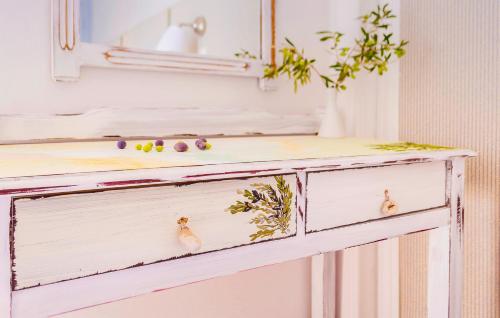 an old dresser with two drawers with flowers on it at Hotel Avlakia in Kokkari
