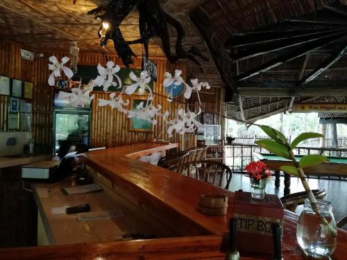 a bar with a long counter in a restaurant at Big BamBoo Beach Resort Sipalay in Sipalay