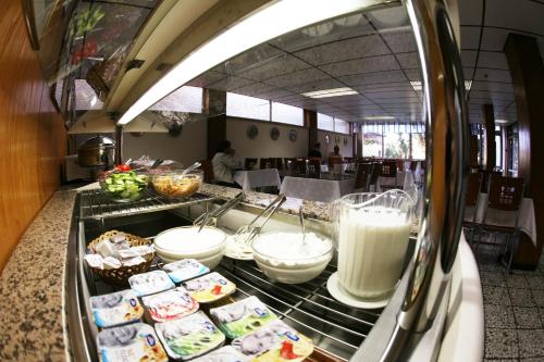 a buffet line with food and milk in a restaurant at Beth-Shalom in Haifa