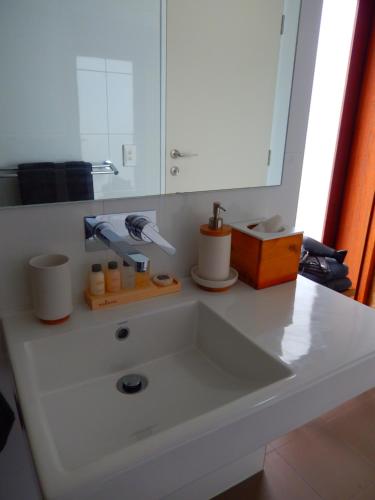 a white sink in a bathroom with a mirror at Morialta Barns in Norton Summit
