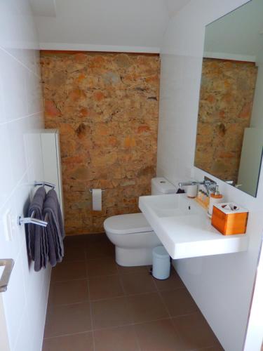 a bathroom with a white sink and a toilet at Morialta Barns in Norton Summit