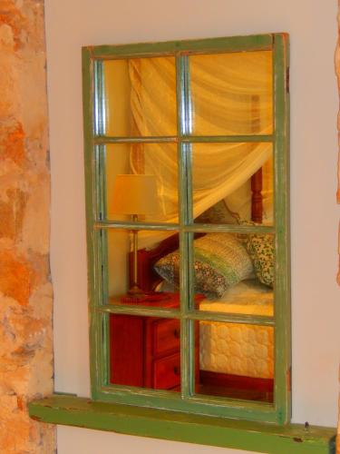 a green window in a room with a bed at Morialta Barns in Norton Summit