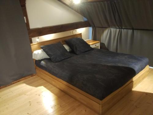 a bedroom with a bed with two pillows on it at Loft Zola in Dijon