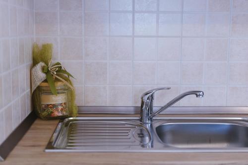 a kitchen sink with a potted plant next to it at SeaView Apartments in Koper