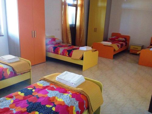 Кровать или кровати в номере Ostello Bella Calabria