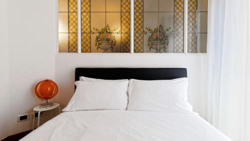 a bedroom with a bed and a stained glass window at Italianway - Dogana 3 in Milan