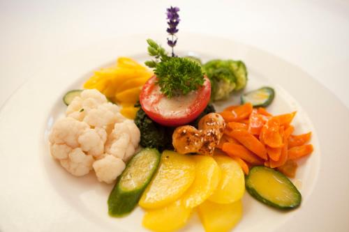 a plate of vegetables on a white plate at Hotel Arvenbüel in Amden
