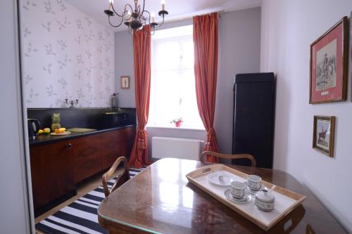 a kitchen with a dining room table and a window at Crystal Suites Old Town in Krakow