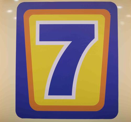a blue and yellow parking sign with a number seven at 7Days Inn Huizhou West Lake in Huizhou