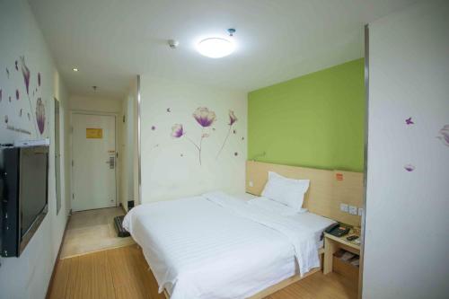 7Days Inn Huizhou West Lake tesisinde bir odada yatak veya yataklar
