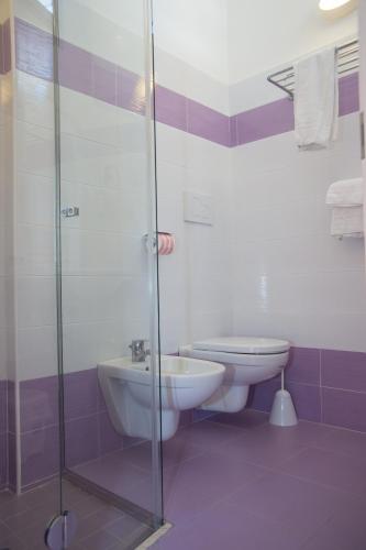 a bathroom with a sink and a toilet and a shower at Hotel Tivoli in Misano Adriatico