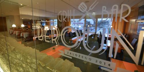 a reflection of a restaurant in a glass window at Hotel Grand Litava Beroun in Beroun