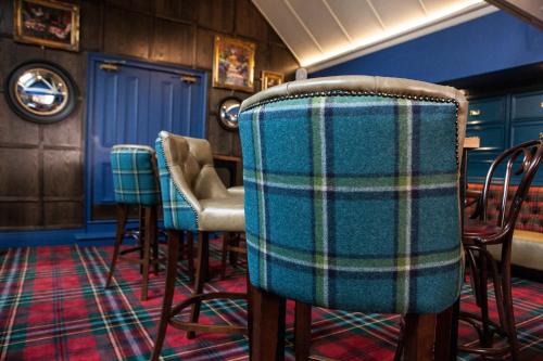 a row of chairs in a room with blue walls at Blackwell Grange Hotel in Darlington
