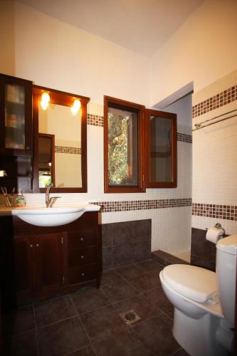 a bathroom with a sink and a toilet at Ktima Kehrioti in Panormos Skopelos