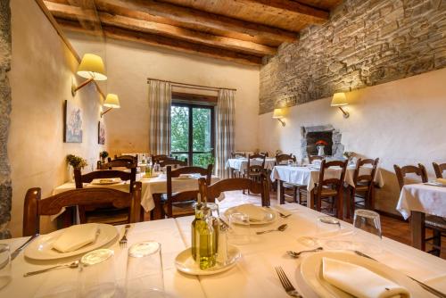 a restaurant with tables and chairs and a fireplace at Hotel Akerreta in Akerreta