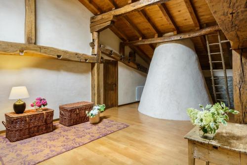 a living room with a table and a large fireplace at Hotel Akerreta in Akerreta