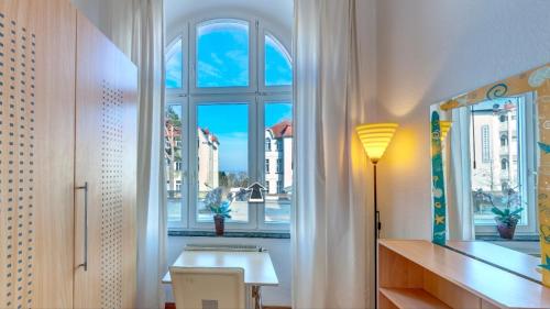 a room with a window with a table and a lamp at Villa Carola - 100 m zum Strand in Bansin