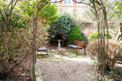 a garden with two chairs and a bench at Jesmond Hotel in London