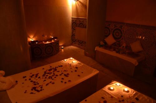 a bathroom with a bath tub and a table with candles at Caribbean Village Agador - All inclusive in Agadir