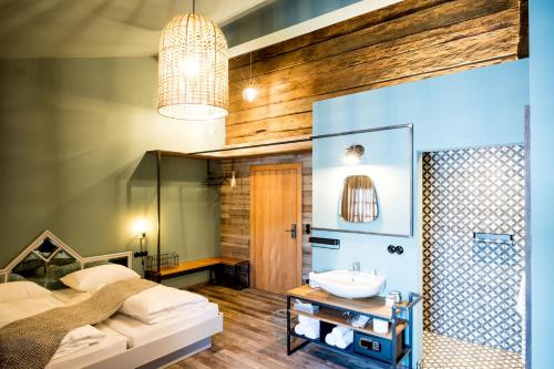 a bathroom with a bed and a sink at Peakini Farmhaus in Untertauern
